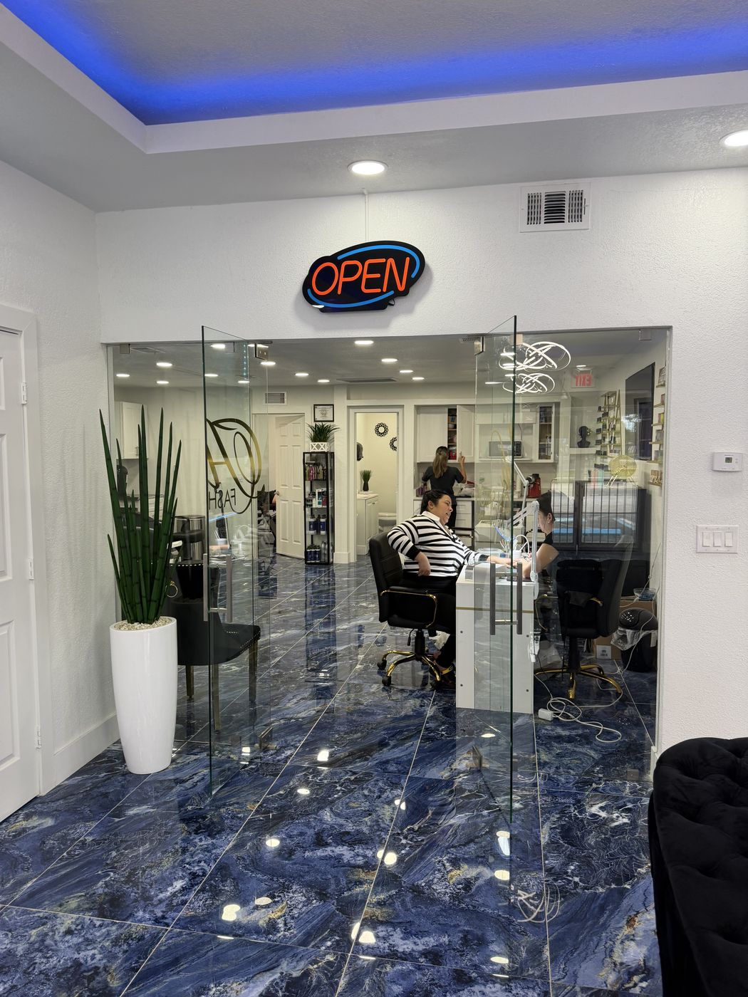 Glass door inside Los Joyeritos leading into Adi Fashion Salon